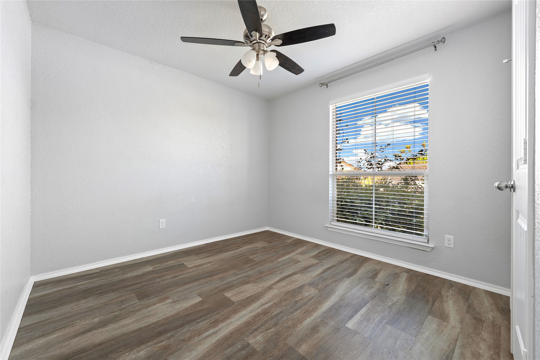133 Beth Ann Loop Taylor, TX 76574 - Photo 16 of 30 Front bedroom #2 featuring dark wood-type flooring, ceiling fan, and a textured ceiling