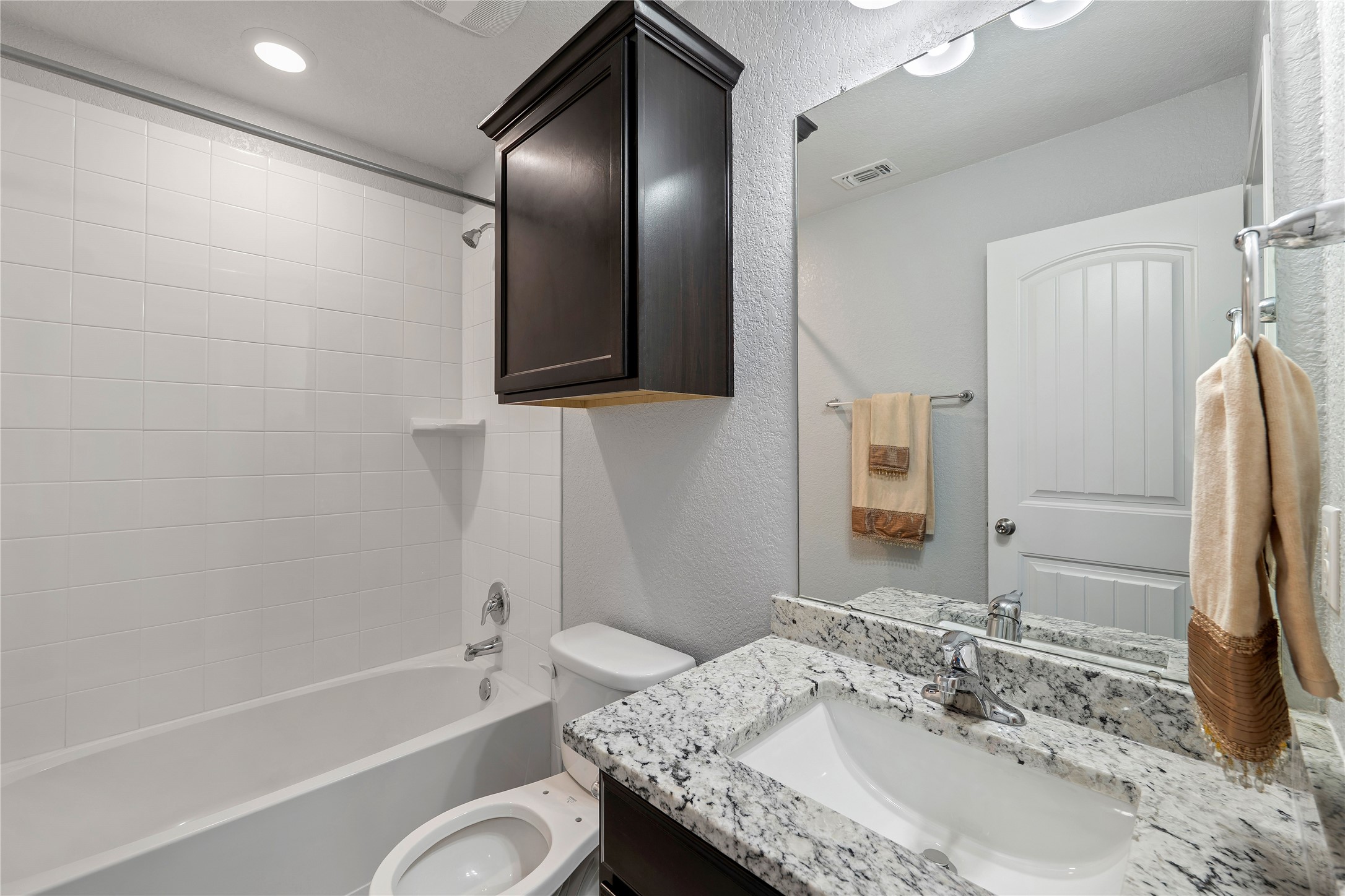 133 Beth Ann Loop Taylor, TX 76574 - Photo 18 of 30 Bathroom featuring a textured wall, vanity, and shower / bathtub combination