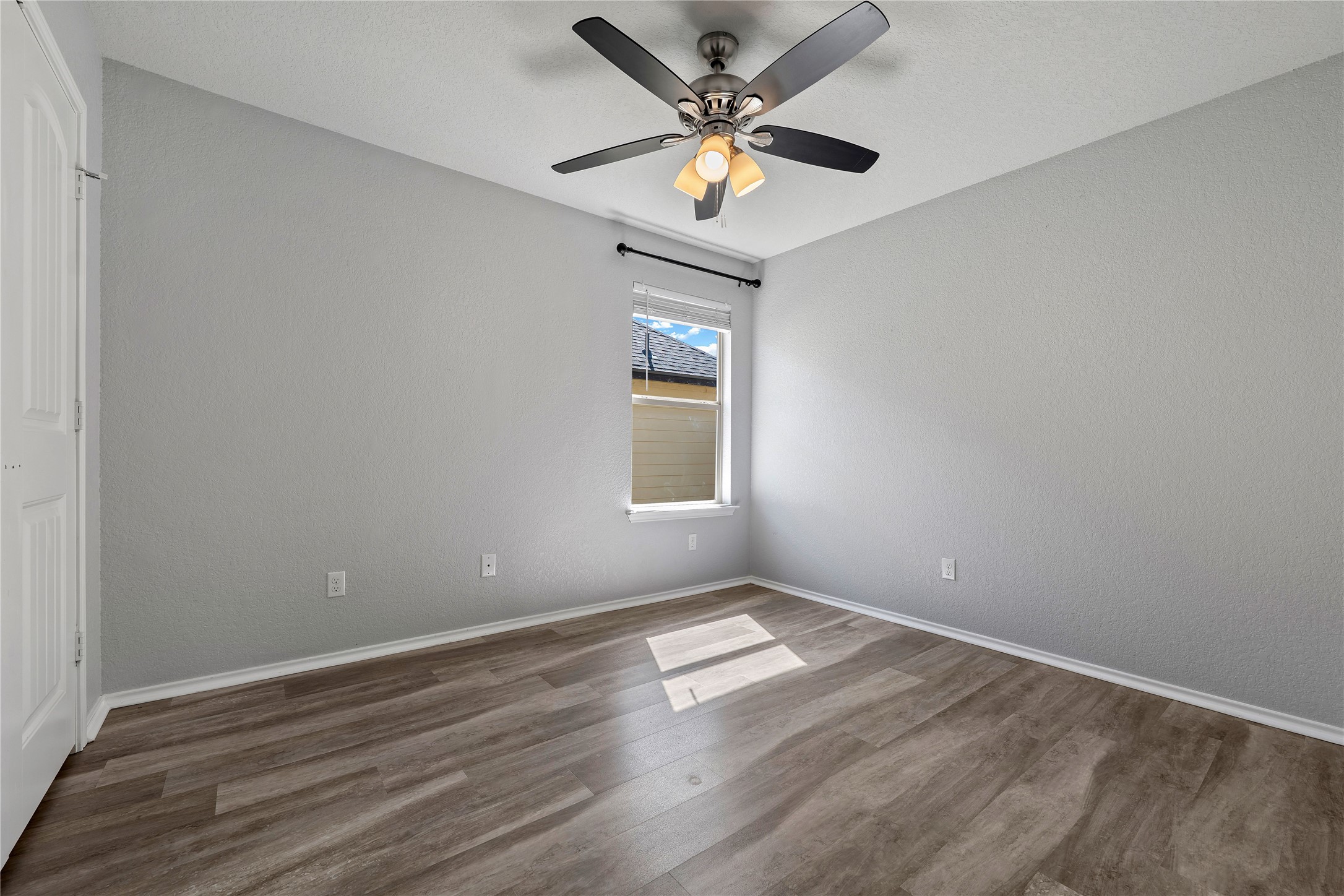 133 Beth Ann Loop Taylor, TX 76574 - Photo 21 of 30 Bedroom#4 with a ceiling fan, light dark engineering flooring, and a closet