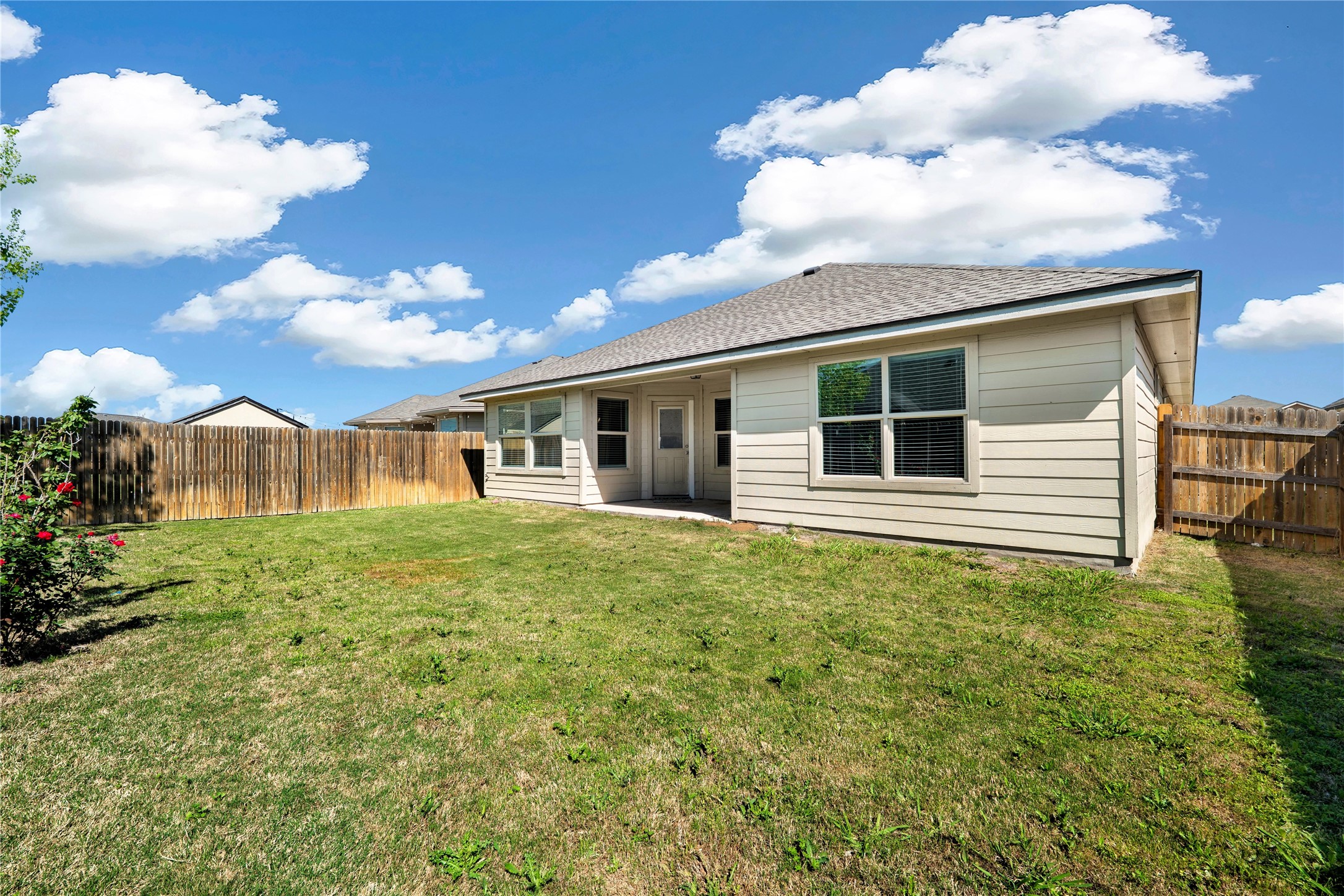 133 Beth Ann Loop Taylor, TX 76574 - Photo 23 of 30 Rear view of house featuring a patio area, a fenced backyard, and roof with shingles