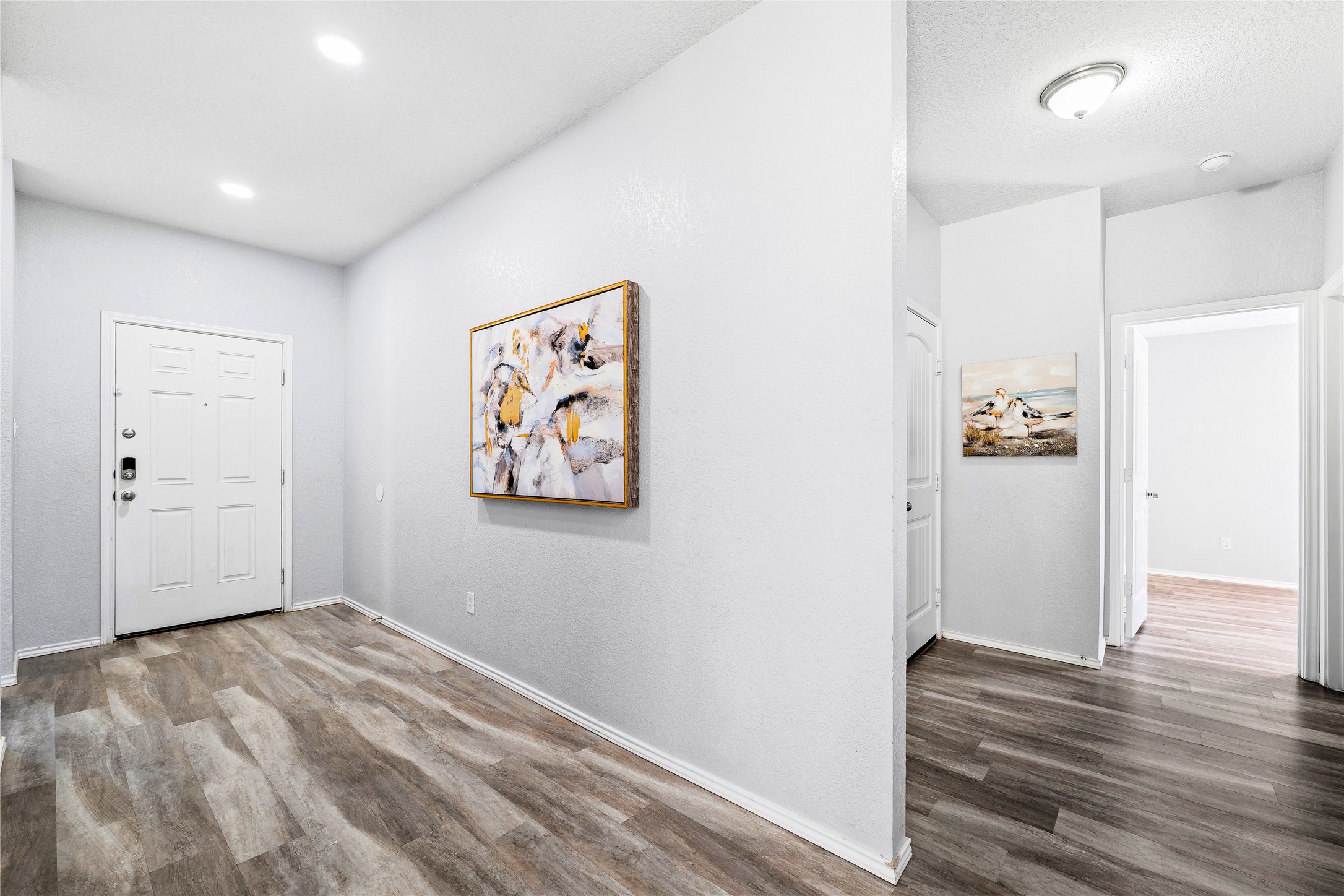 133 Beth Ann Loop Taylor, TX 76574 - Photo 28 of 30 Foyer entrance with dark engineering flooring