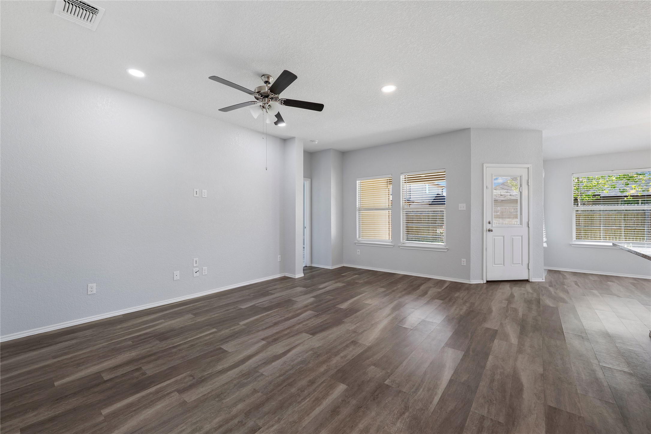 133 Beth Ann Loop Taylor, TX 76574 - Photo 4 of 30 Unfurnished living room featuring ceiling fan, dark engineering flooring and recessed lighting