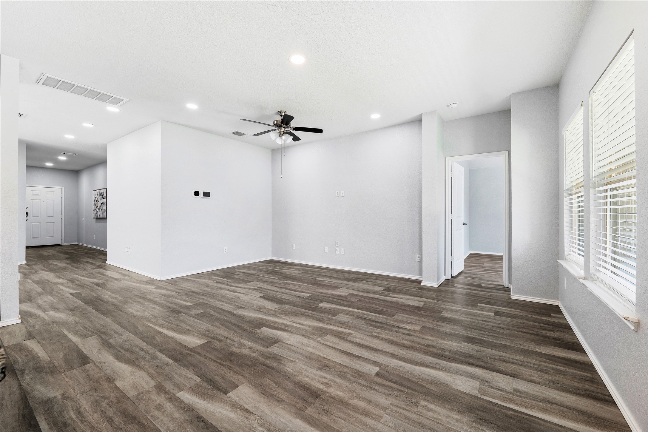 133 Beth Ann Loop Taylor, TX 76574 - Photo 6 of 30 Unfurnished living room featuring a ceiling fan, recessed lighting, and dark engineering flooring