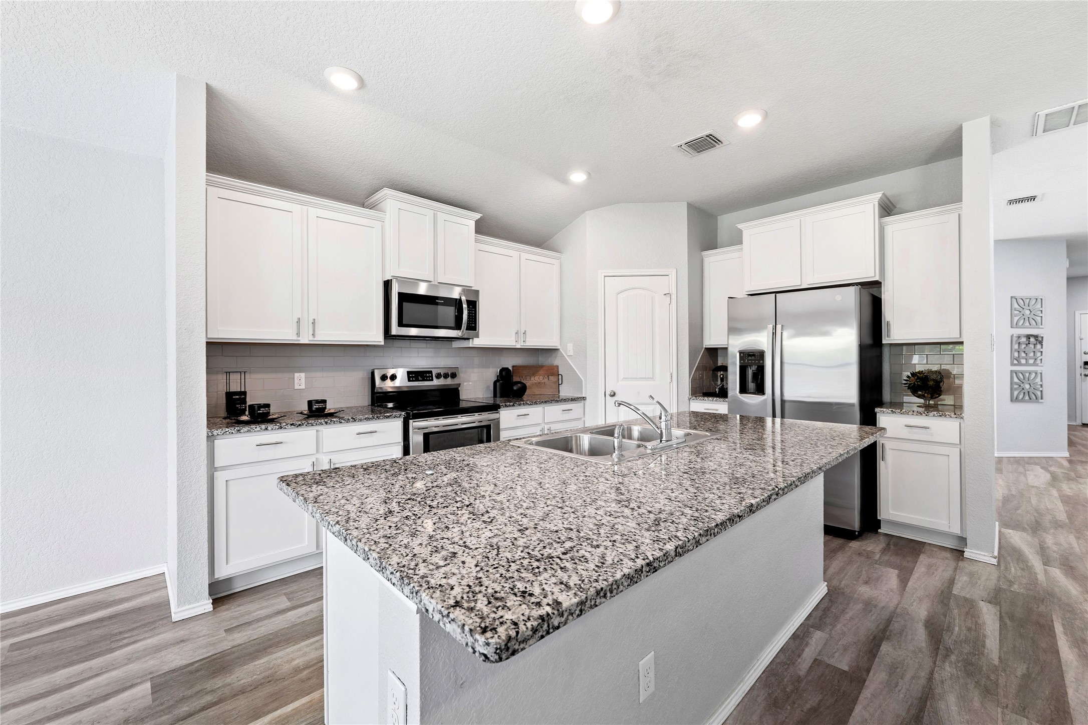 133 Beth Ann Loop Taylor, TX 76574 - Photo 9 of 30 Kitchen featuring stainless steel appliances, light stone countertops, white cabinets, and recessed lighting