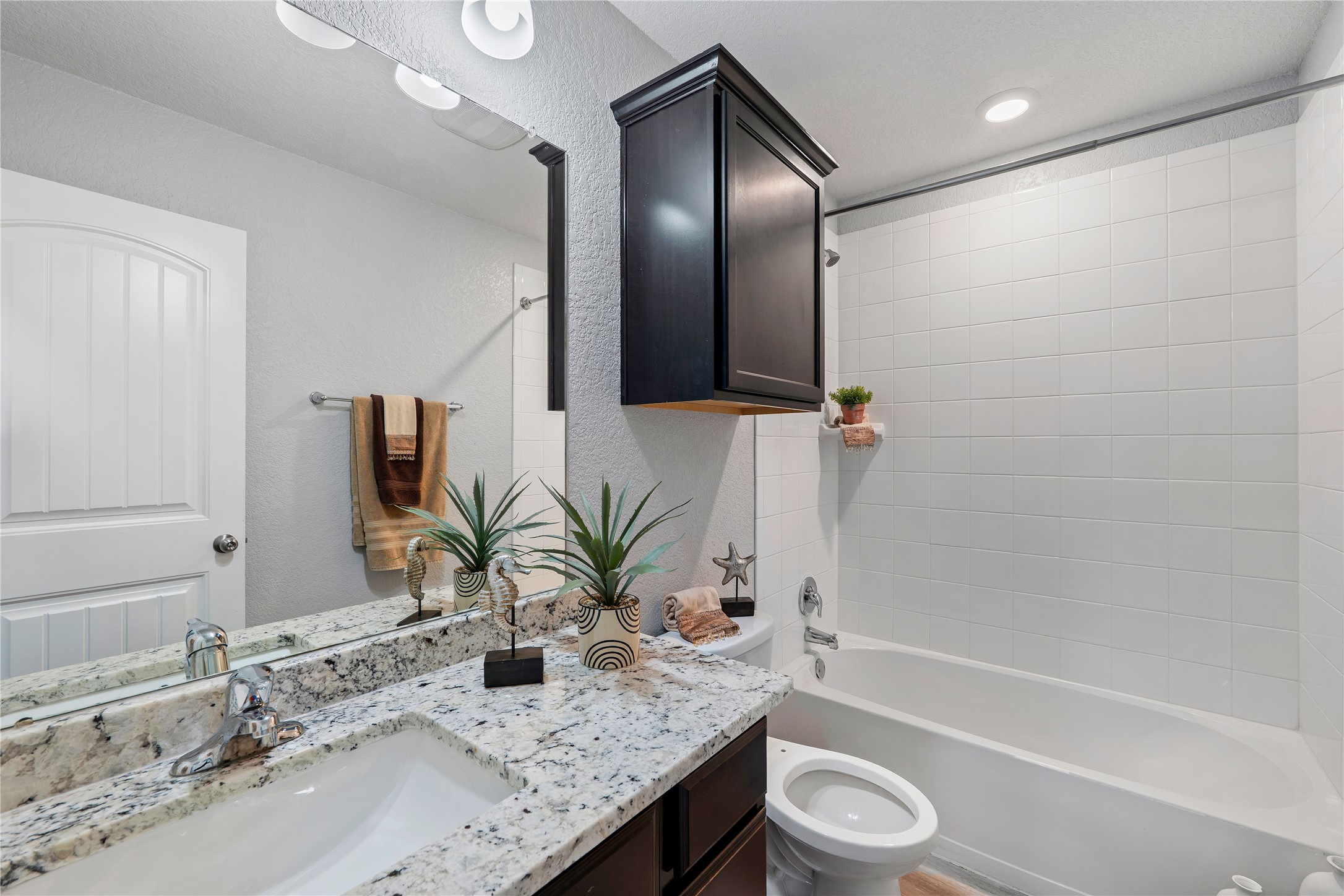 133 Beth Ann Loop Taylor, TX 76574 - Photo 10 of 30 Bathroom featuring vanity, shower combination, and a textured wall