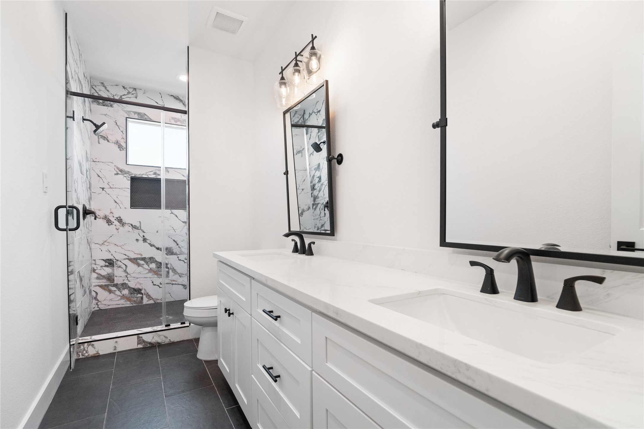 1112 Hogan Street Houston, TX 77009 - Photo 16 of 31 a bathroom with a double vanity sink mirror and shower