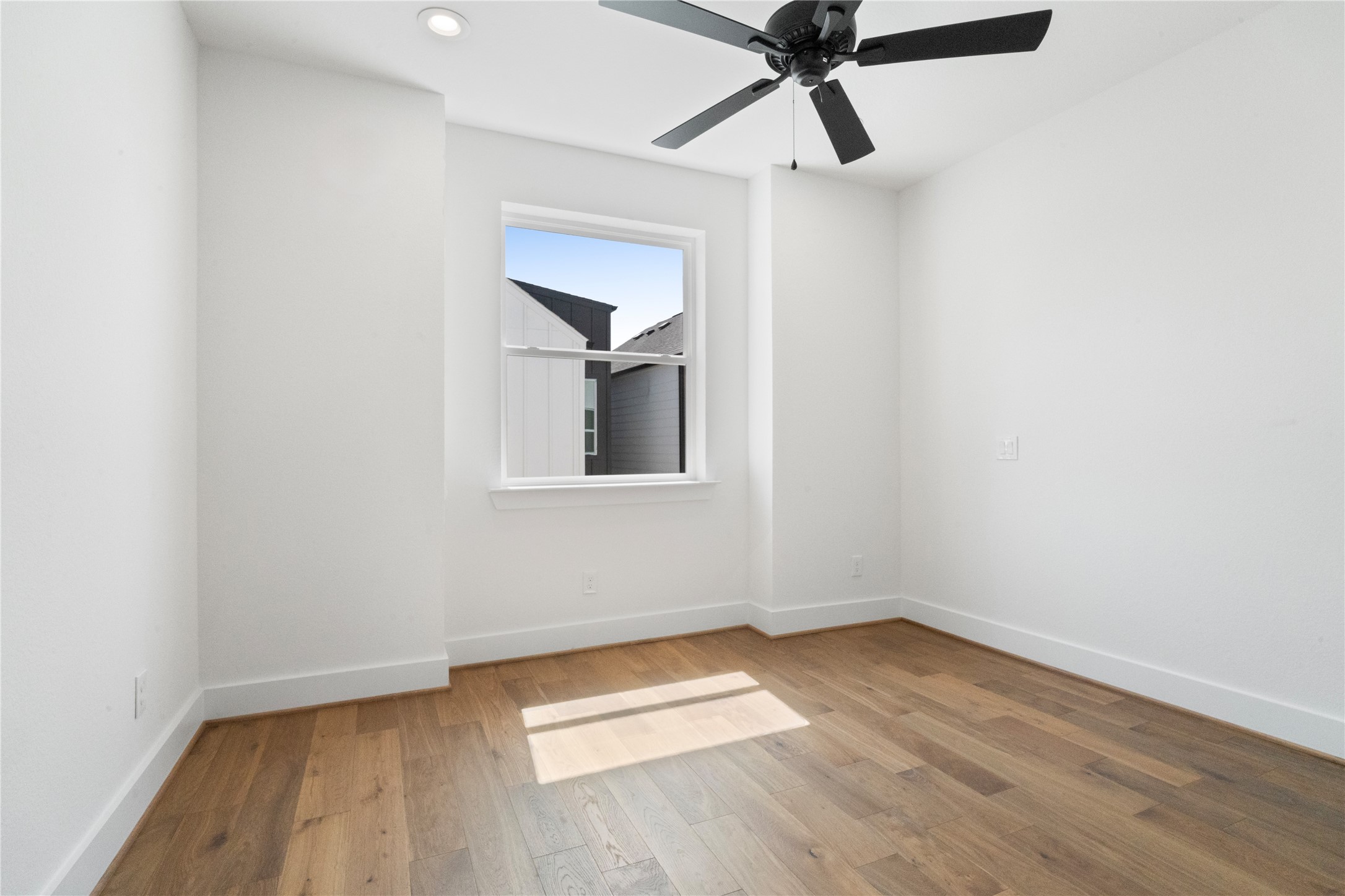 1112 Hogan Street Houston, TX 77009 - Photo 19 of 31 a view of empty room with wooden floor and fan