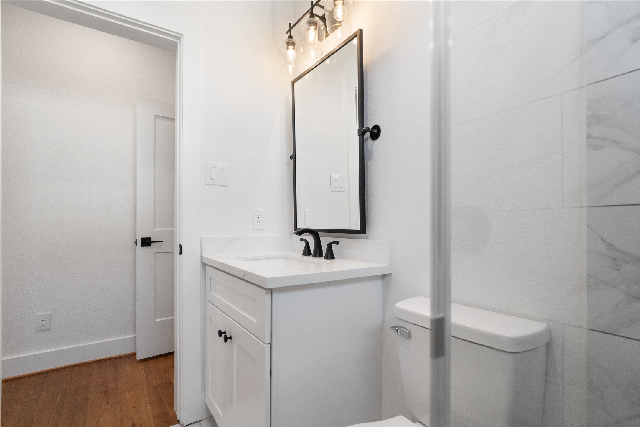 1112 Hogan Street Houston, TX 77009 - Photo 22 of 31 a bathroom with a sink and mirror with toilet