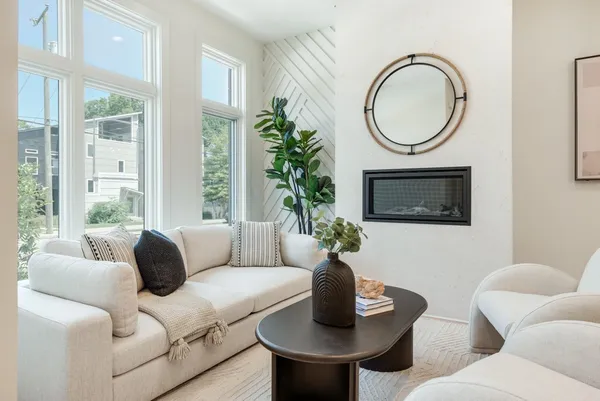 a living room with furniture a window and a fireplace