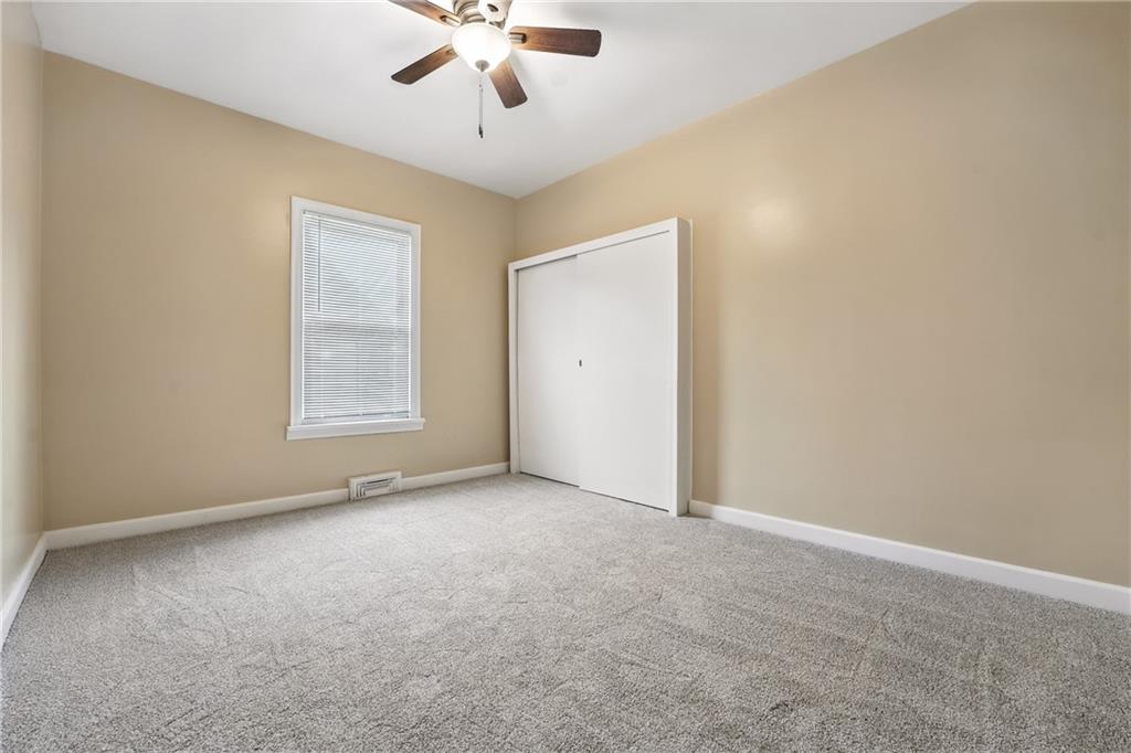 1430 Old Butler Road New Castle, PA 16101 - Photo 16 of 31 an empty room with a chandelier fan and windows