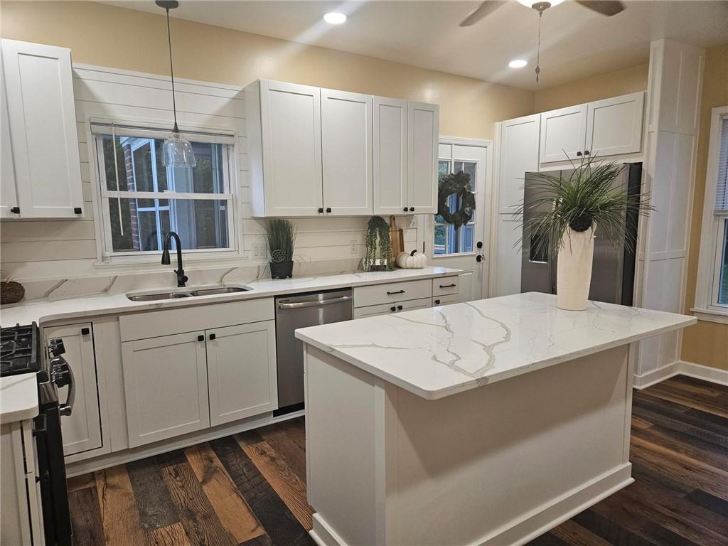 1430 Old Butler Road New Castle, PA 16101 - Photo 3 of 31 a kitchen with kitchen island white cabinets appliances and a chandelier