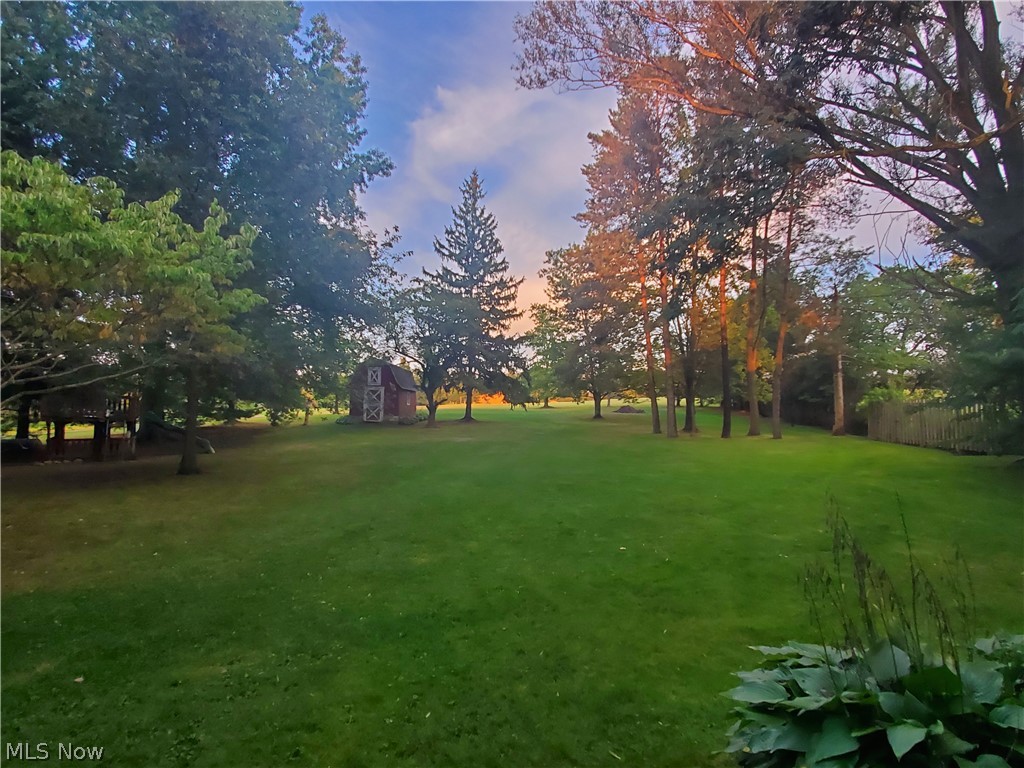 10141 Cutts Road Chardon, OH 44024 - Photo 23 of 24 Back yard of 1 acre lot showing small barn and on the left is a kids play set