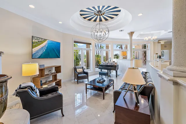 a living room with furniture a rug and a chandelier
