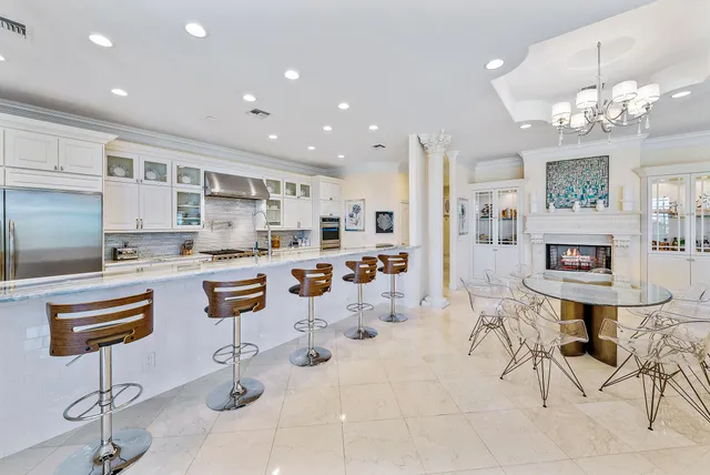 a kitchen with stainless steel appliances kitchen island granite countertop a sink and cabinets