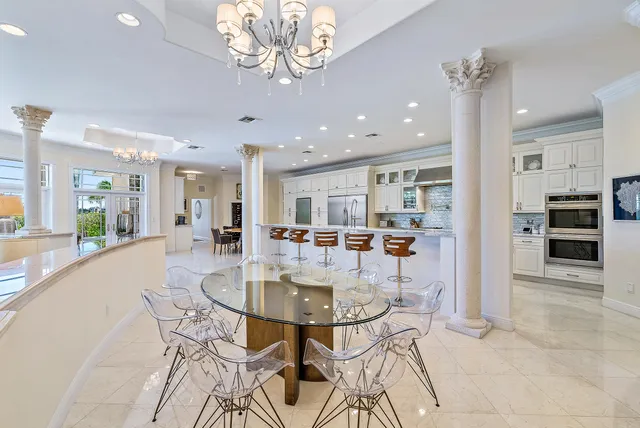 a dining room with furniture and a kitchen view