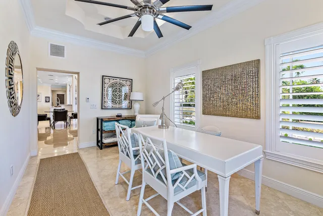 a view of a dining room with furniture and a window
