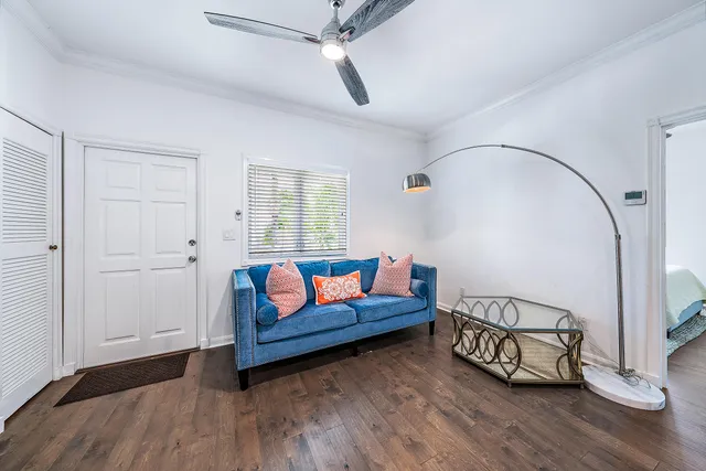 a living room with furniture and wooden floor