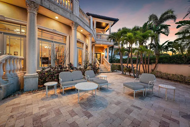 a living room with patio furniture and a potted plant