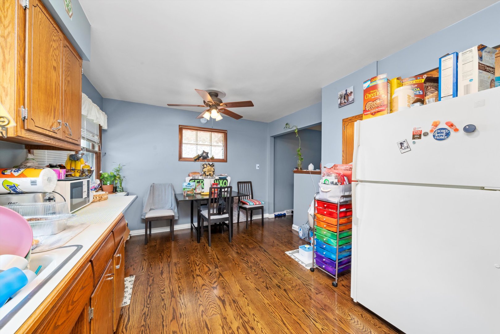 10529 Lyman Avenue Chicago Ridge, IL 60415 - Photo 24 of 45 a utility room with fridge wooden floor a sink and a window