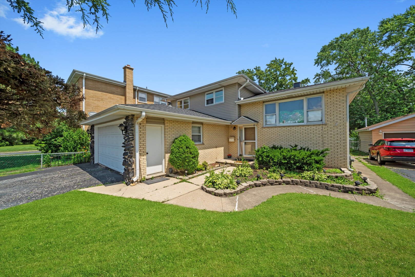 10529 Lyman Avenue Chicago Ridge, IL 60415 - Photo 45 of 45 a front view of a house with a garden and plants