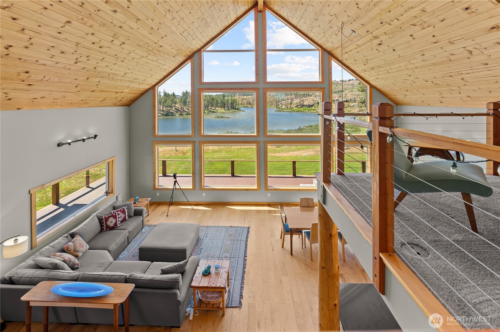 30 Shalberg Lake Road Riverside, WA 98849 - Photo 13 of 40 a living room with furniture and a floor to ceiling window with outer view