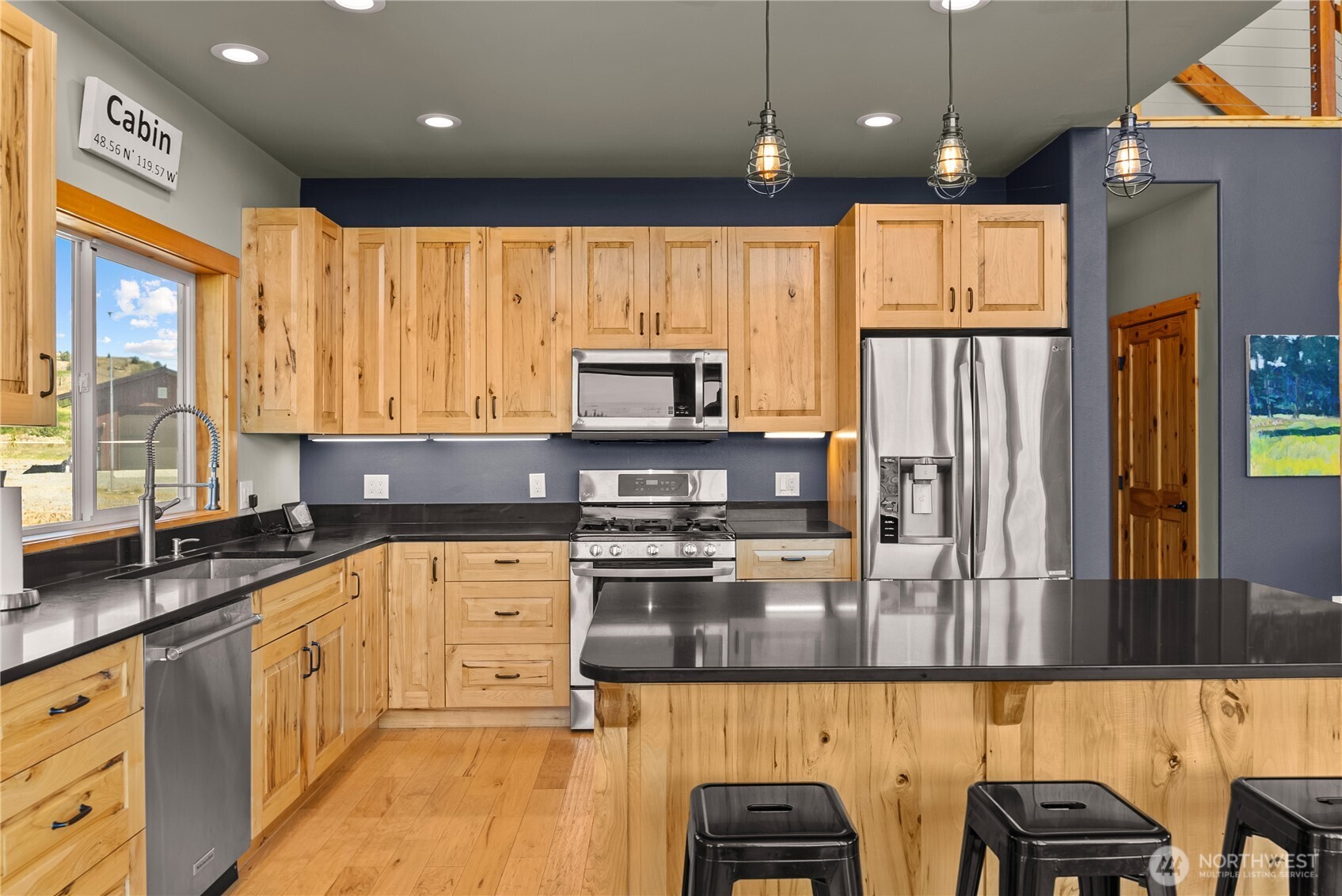 30 Shalberg Lake Road Riverside, WA 98849 - Photo 8 of 40 a kitchen with stainless steel appliances granite countertop a refrigerator a sink dishwasher a stove and white countertops with wooden floor