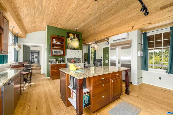 a view of living room with furniture and wooden floor