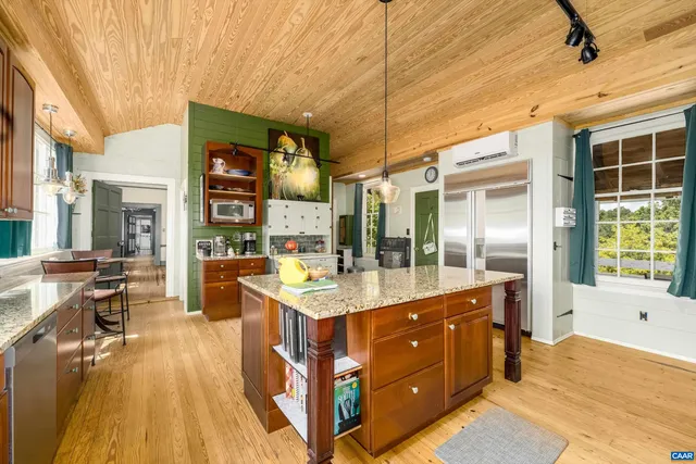 a view of living room with furniture and wooden floor