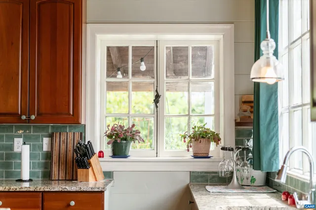 a spacious bedroom with a bed fireplace and window