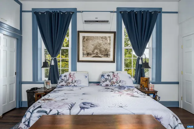 a bedroom with bed and wooden floor