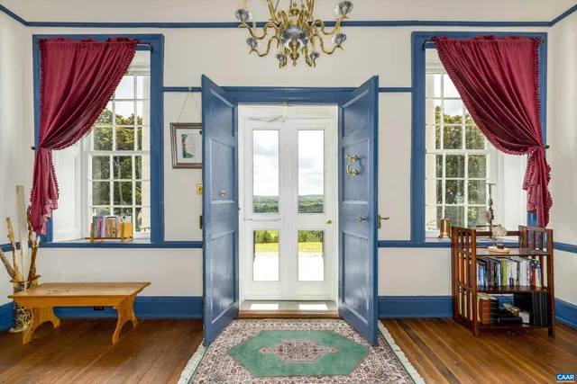 a view of a bedroom with furniture and window