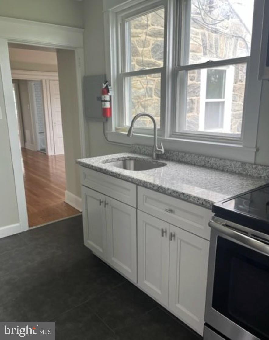 38 Copley Road Upper Darby, PA 19082 - Photo 11 of 22 a kitchen with granite countertop a stove and a sink