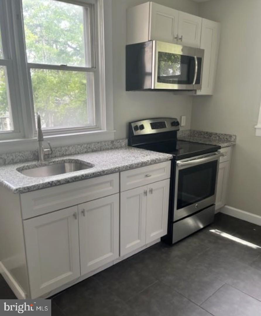 38 Copley Road Upper Darby, PA 19082 - Photo 12 of 22 a kitchen with a stove and a sink