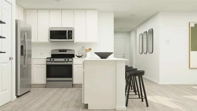 a kitchen with a refrigerator sink and stove