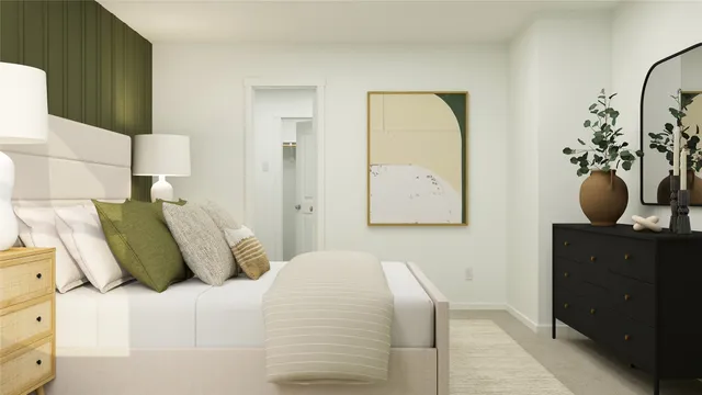 a bedroom with a bed and painting on the wall