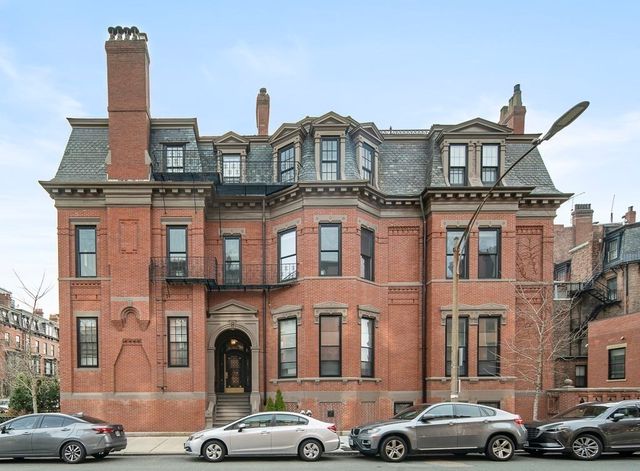 a front view of a residential apartment building with a yard