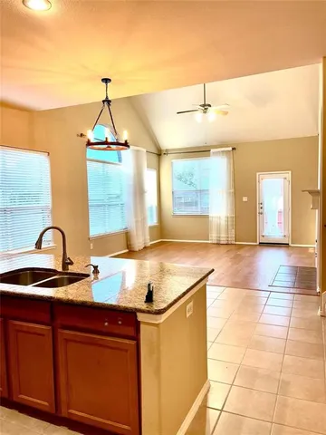 a view of a kitchen with a sink and furniture