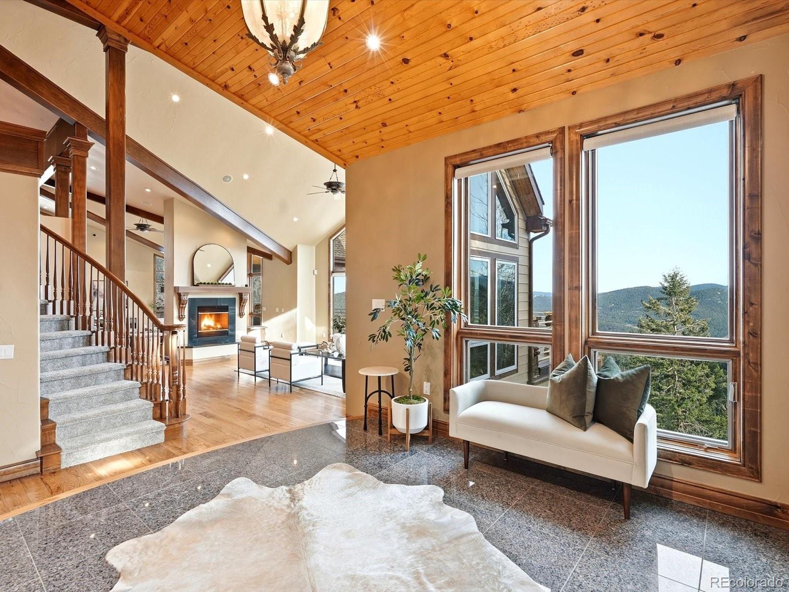 187 Fox Ridge Drive Evergreen, CO 80439 - Photo 11 of 50 a living room with furniture and a large window