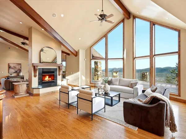 a living room with fireplace furniture and a large window