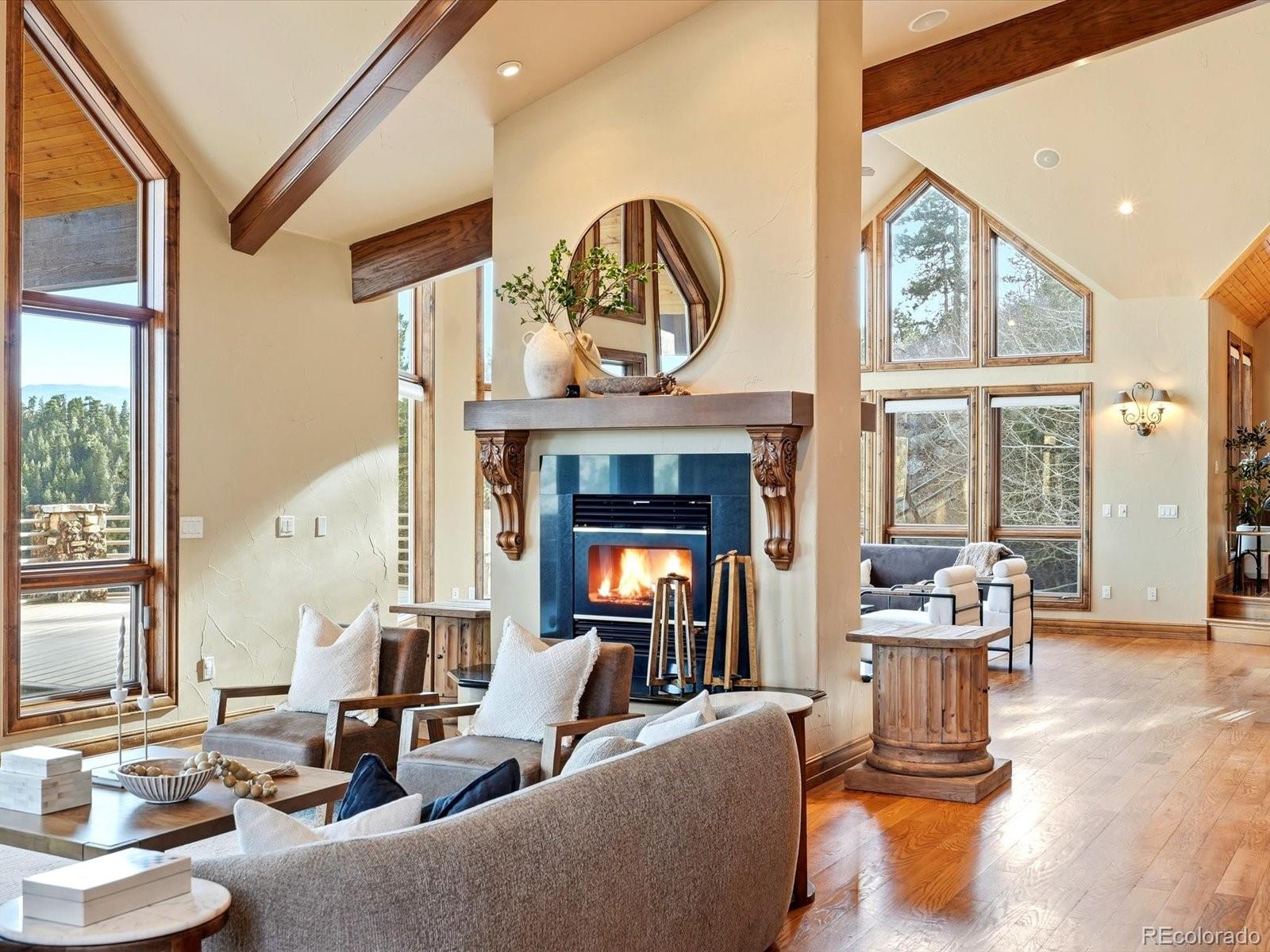 187 Fox Ridge Drive Evergreen, CO 80439 - Photo 14 of 49 a living room with fireplace furniture and a large window