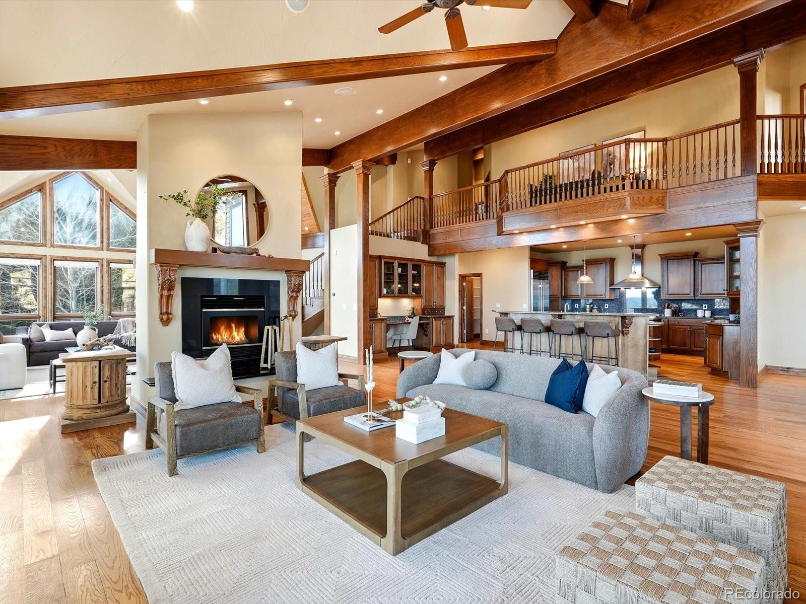 187 Fox Ridge Drive Evergreen, CO 80439 - Photo 15 of 49 a living room with furniture a fireplace and a large window