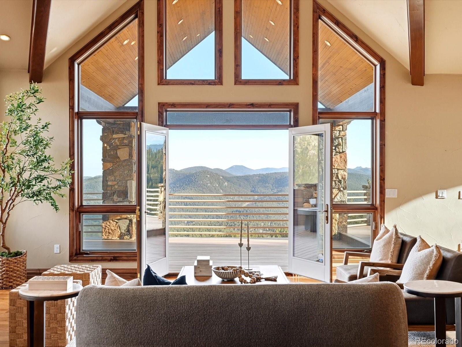 187 Fox Ridge Drive Evergreen, CO 80439 - Photo 16 of 49 a living room with a large window