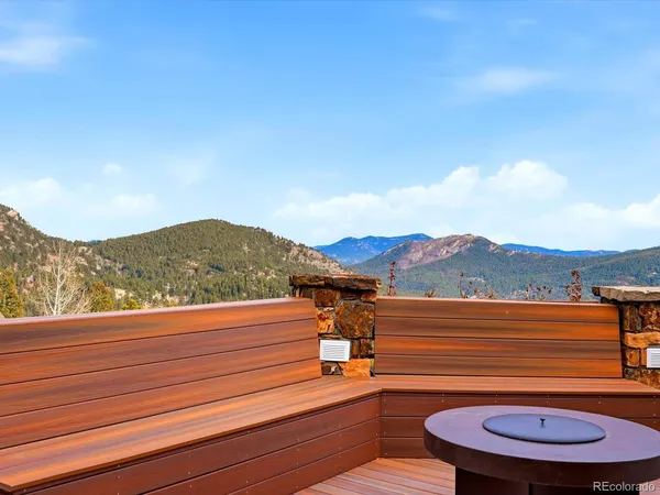 a view of a balcony with wooden floor and outdoor seating