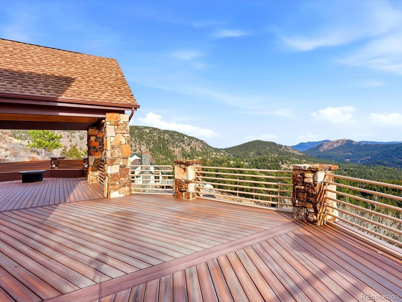 187 Fox Ridge Drive Evergreen, CO 80439 - Photo 19 of 49 a view of a balcony with wooden floor and outdoor seating
