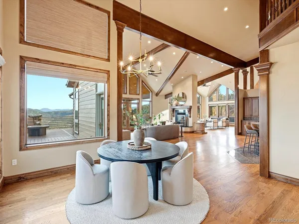 a dining room with lots of wooden furniture and a view of kitchen