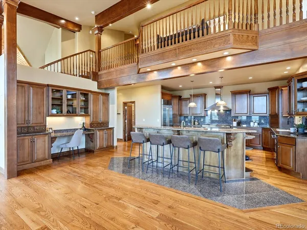 a kitchen with stainless steel appliances granite countertop a sink a stove and a refrigerator