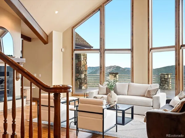 a spacious bedroom with a bed a couch and large windows