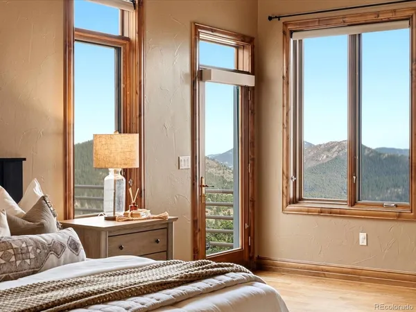a bedroom with a large bed and a chandelier