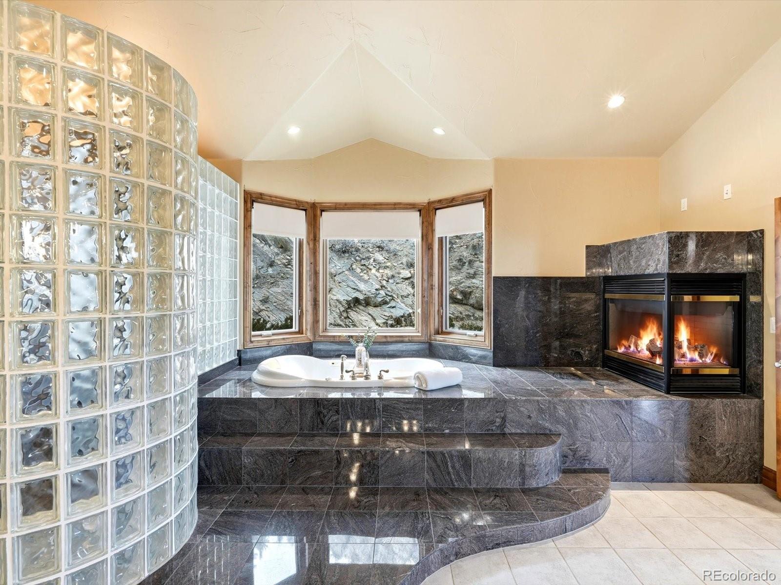 187 Fox Ridge Drive Evergreen, CO 80439 - Photo 34 of 49 a living room with fireplace furniture and a large window