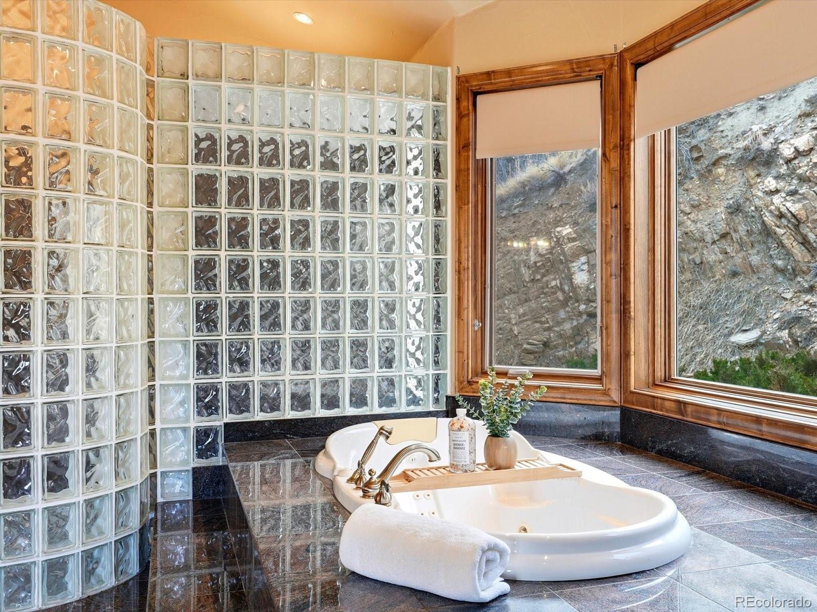 187 Fox Ridge Drive Evergreen, CO 80439 - Photo 35 of 49 a bathroom with a bathtub and shower